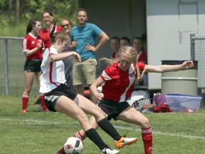 Woodstock Collegiate Institute Red Devil's Kelly Maloney, right, fights for the ball with a Lord Dorchester player in St. Thomas, Ont. on Tuesday May 29, 2018 in the TVRA 'A' Southeast Division finals. Lord Dorchester won 3-2. Greg Colgan/Woodstock Sentinel-Review/Postmedia Network