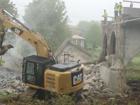 Engineers look on as the main part of the Chesley bridge came down on May 23. (Jane Kent/Postmedia Network)