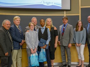 Winners of the 2018 Mayor For a Day Challenge, middle school student Maddox Nelles and high school student Timoni Ifidon, pose with members of council on May 22.