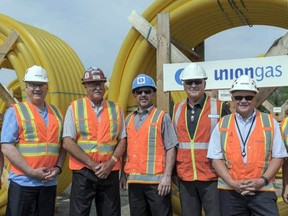 Liane Seguin, Union Gas construction project manager, Coun. Michael Matthews, Mayor Ken Lamming, Coun. Enzo Palumbo, Glen Huard, Union Gas construction and growth manager, Don Van Daele, recently retired as Union Gas’s utility services manager for Sault Ste. Marie and Prince CAO Peggy Greco, stand in front of  multiple spools of four-inch piping as natural gas pipelines arrived Wednesday in Prince Township. Marguerite LaHaye/Special to The Star