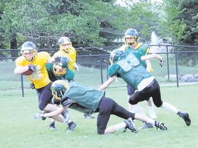 Canmore Collegiate Wolverines ball carrier Albert Reed tries to elude would-be tacklers Will Pentland and Will Pollard during a spring practice for the high school football team on Wednesday, May 23, 2018. Russ Ullyot/ Bow Valley Crag & Canyon/ Postmedia Network