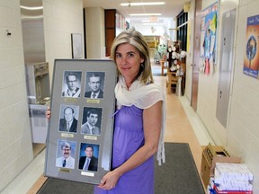 Central Perth Elementary School principal Andrea Paetkau holds a frame of former principals, including Bob Hawley, top left, inside the school on Wednesday, May 30, 2018 in Wartburg, Ont. Terry Bridge/Stratford Beacon Herald/Postmedia Network