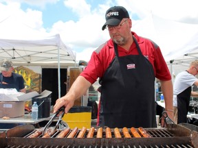 Henry Groenestege of the Perth County Pork Producers Association barbecues hot dogs during the 2017 Ontario Pork Congress. The OPC returns June 20 to 21 followed by Stratford Blues and Ribfest. Terry Bridge/Stratford Beacon Herald/Postmedia Network