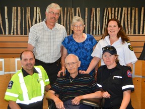 Donald Garland, front and centre, with paramedics who saved him, Dennis Mengotto, left, and Sara Pickard, right, on a call to his Hanover home June 29, 2017. His son, Tom Garland, wife Shirley Garland, and the ambulance dispatcher who took the 911 call, Tracey White, stand behind them after the seventh annual Second Chance Reunion Luncheon at the Grey County building on Wednesday in Owen Sound. (Scott Dunn/The Sun Times)
