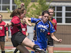 Anna Kozbor (left) of Paris District High School vies for the ball with Alex Dockx of Simcoe Composite School on Wednesday during a CWOSSA girls soccer game at Kiwanis Field in Brantford. (Brian Thompson/The Expositor)