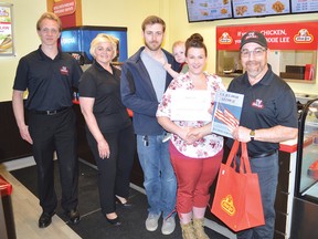Photo by KEVIN McSHEFFREY/THE STANDARD
Shawn Struik and Maria Struik - of Dixie Lee corporate, along with Don Cook - owner of the Blind River Dixie Lee franchise, present Cady Taylor and Joey Schellekens, of Blind River, along with one of their three children, with the couple’s prize, having won the Dixie Lee Fried Chicken’s Weekend Getaway.