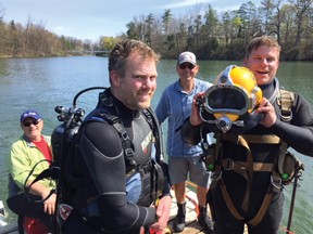 Kinsmen Fountaineers John Glass (centre) and barge skipper Kin Floyd Marshall are flanked by professional divers Mike Johnson and new Kinsmen Jush Matheson (right) as they prepare their gear and safety equipment before going out to find and retrieve the Town’s fountain from the murky depths of Lake Lisgar. (Contributed photo/Pat Carroll - Kinsmen)