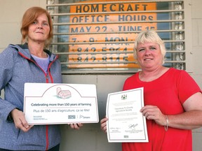 Rosemary Dean and Tracy Green hold the Ontario 150 plaque and certificate recently received by the Tillsonburg Tri-Country Agricultural Society Fair, now preparing for its 164th year June 22-24. (Chris Abbott/Tillsonburg News)