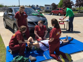 Sabrina Maisonneuve, Carina Lyrette, Anabelle Breton- Périgny and Chloe Nolet-Chartrand care for a mock patient during a medical competition at La Cité collégiale. École secondaire catholique Thériault has won the contest for the past three years now.