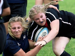 Northern Vikings' Bronwen Brickett, right, is tackled by Ursuline Lancers' Selena Bushey in the LKSSAA senior girls' rugby final at Ursuline College Chatham in Chatham, Ont., on Wednesday, May 30, 2018. (Mark Malone/Postmedia Network)