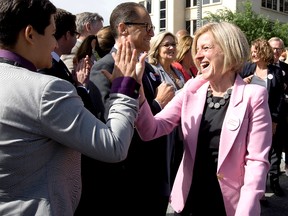 Alberta Premier Rachel Notley (right) high-fives Strathcona-Sherwood Park MLA Estefania Cortes-Vargas following a press conference where Notley announced that the Government of Canada, with support from the Government of Alberta, has purchased the Trans Mountain Pipeline and associated assets, on Tuesday, May 29.

David Bloom/Postmedia Network