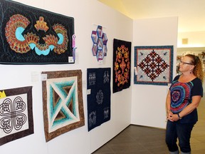 Lake of the Woods Quilter's Guild member Kathy Dawe was available to answer questions from the public on Wednesday regarding entries in the group's 33rd annual quilt show now on display at the museum until June 23. This year's show features 58 quilts and wall hangings in different styles, types and quilting techniques.
Reg Clayton/for The Enterprise