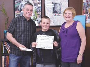 May Youth of the Month winner Mason Campbell receives a certificate and a cheque for $100 from the Chantal Bérubé Memorial Fund to recognize his hard work and dedication to the youth centre.