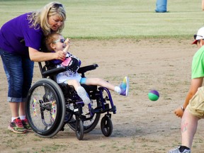 Photo courtesy Field of Ability
Field of Ability chairwoman Lisa Newman-Chesher helps Alyssa Theobald play Challenger baseball against pitcher/coach Josh Freeburn at Loyalist College in Belleville.