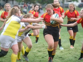 GORDON ANDERSON/DAILY HERALD-TRIBUNE
Sarah Finlayson of the Sexsmith High School Sabres rugby team breaks through numerous tackles against the Charles Spencer High School Mavericks during the Peace Country 15s girls rugby championship at Macklin Field on Wednesday night. The Sabres built up a 25-0 lead and held on for a 25-15 victory.