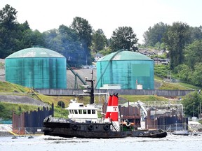 A tug boat passes by Kinder Morgan's Trans Mountain marine terminal, in Burnaby, B.C., on Tuesday, May 29, 2018. THE CANADIAN PRESS Jonathan Hayward