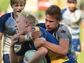 BCI ball carrier Aiden Vachon reacts to a high tackle by Boston Thomas of the Sir John A. MacDonald (Waterloo) Highlanders on Thursday during the CWOSSA junior boys rugby championship match at the Harlequin Grounds. (Brian Thompson/The Expositor)