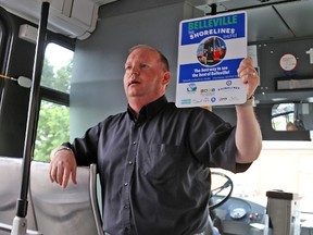 TIM MEEKS/THE INTELLIGENCER
Paul Buck, manager of transit operations for the City of Belleville, holds up one of the bus stop signs that will be erected along the route of the Shorelines Shuttle Tour, which launched Friday and will operate until September 2.