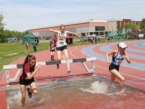 Athletes compete in the open girls 1500 metre steeplechase event at the NOSSA track and field championships at the track at Laurentian University in Sudbury, Ont. on Wednesday May 30, 2018. The meet wraps up today. John Lappa/Sudbury Star/Postmedia Network