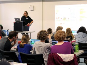 Mistene Clapp (standing) leads a Girls Learning Code workshop on Saturday, May, 12 2018.