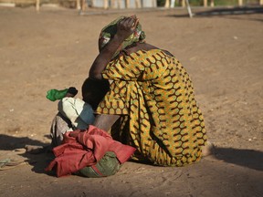 A South Sudanese refugee woman sits with her child at a refugee collection centre in Palorinya, Uganda.
AP Photo/Justin Lynch)