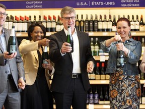 (From left) Fred Godbille, Chair of the 2018 United Way, Monica Kahindo, director of resource development at the United Way of the KFLA, George Soleas, president and CEO of the LCBO, Joyce Gray, chief customer officer of the LCBO, and  Cherrie Summer, manager of the new LCBO in the Riverview Shopping Centre on Highway 15 in Kingston, Ont. on Friday June 1, 2018. The group celebrated the opening by popping bottles of Hinterland sparkling wine.