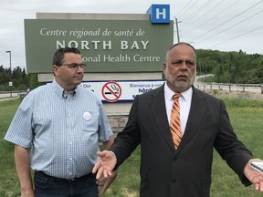 NDP candidate Henri Giroux held a media conference outside the North Bay Regional Health Centre to warn voters support for Progressive Conservative leader Doug Ford will mean hospital cuts.