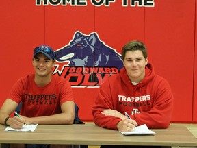 Ernie Fidder (left) and Connor Czibere sign with the Edmonton Huskies at Bill Woodword school in Anzac, Alta. on May 31, 2018. Laura Beamish/Fort McMurray Today/Postmedia Network