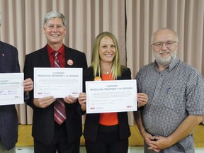 The three main provincial candidates in Haldimand-Norfolk signed a prosperity pledge on behalf of Ontario agriculture at Thursday’s all-candidates meeting in Kohler. From left are Progressive Conservative candidate Toby Barrett, Liberal candidate Dan Matten, NDP candidate Danielle Du Sablon and Bruce Armstrong, president of the Haldimand Federation of Agriculture. HFA sponsored Thursday’s event. MONTE SONNENBERG / SIMCOE REFORMER