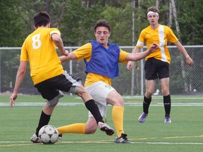 The St. Joseph-Scollard Hall Bears dominated the Korah Collegiate Colts of Sault Ste. Marie to claim the 2018 NOSSA 'AA' seniors boys championship at the new Nipissing University artificial field, Friday. In the photo above, the Bears' Matteo Pavone, blue pinny, defends against a Korah player. Team members include: Juan Arias Iglesias, Adam Courchesne, Stephen Crea, Jaymeson Cundari, Dylan D'Agostino, Ian Denomme, Nathan Desrosiers, Conor Doyle, Matteo Farella, Payton McLeod, Jared Mechefske, Matteo Pavone, Michael Pettella, Nolan Reynolds, Dylan Simon, Shkaabewis Tabobondung, Jacob Wall, Spencer Waltenbury, Riley Yakabuskie, student trainer Lucas Dunne, coaches Carlo Celebre, Robert Pavone, Andrew Hazelwood and Greg Janveau. Dave Dale / The Nugget