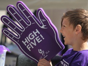 Alex Galizia, 8, holds a giant foam hand before the start of Walk for ALS at Roberta Bondar Pavilion on Saturday. Seven people with ALS from Sault Ste. Marie, Wawa and Dubreuilville are registered with ALS Society of Canada. Tracy Galizia is the group's new regional manager. Her father, Dan McColl, died of ALS in 2014. Sault Ste. Marie is one of 34 communities having walks to raise cash for ALS Society of Canada in May, June and September, said vice-president client services Lisa Droppo. She calls the annual fundraiser “a day to come together and celebrate someone's memory” for families, such as Galizia's, who have died due to the disease.