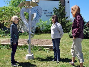 Installation artist Virginia Gail Smith, left, chats about the aluminum sculpture in front of First United Church with Joanne Serre, centre, and Rev. Kristal McGee during Doors Open Owen Sound. DENIS LANGLOIS/THE SUN TIMES