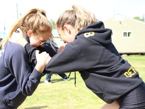 Shelby Deacon, 17, left, and KarLee Lefebvre, 17 practiced their wrestling moves at the D.A.R.E. leadership camp at Camp Bickel on Saturday, June 2. Joshua Santos/The Daily Press.