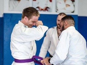 Huron BJJ owner and head instructor Shaun Gregory emotionally accepts his purple belt from top BJJ practitioner and world champ Jorge Britto and his head instructor, Stratford BJJ’s Ryan O’Shea.
