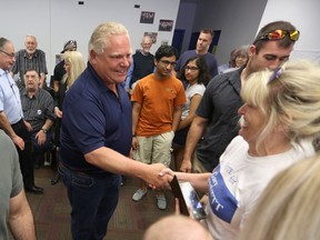 Progressive Conservative Leader Doug Ford greets supporters during a whistle stop at Kingston and the Islands candidate Gary Bennett’s office in Kingston on Sunday. (Meghan Balogh/The Whig-Standard/Postmedia Network)