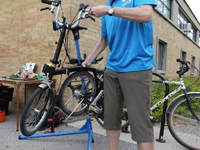 Hal Cain stands with his foldable bicycle at the bike repair station at the Memorial Centre Farmers Market on Sunday. The cycling appreciation day at the market kicked off Cycling Week in Kingston, which features events happening June 3-9. (Meghan Balogh/The Whig-Standard/Postmedia Network)