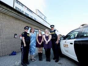 Ontario Provincial Police Const. Shannon Cork, from left, Napanee District Secondary School teacher Sue Marriott, students Angela Meise and Rhianna Vautrin, and Insp. Scott Semple met at Bouler House Cinema in Napanee to see the debut screening of anti-mischief videos that the school and local OPP partnered to create. (Meghan Balogh/The Whig-Standard/Postmedia Network)