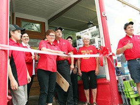 Cutting the bow to signify new ownership, Tracy (Sills) McKee, has purchased Sills Home Hardware in Seaforth with her husband Jeff McKee, the town was welcomed to celebrate the grand opening June 1. (Shaun Gregory/Huron Expositor)