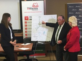 Transportation Minister Brian Mason (centre) shows off plans for a $90-million replacement of Strathcona County's Vinca Bridge, flanked by Fort Saskatchewan-Vegreville MLA Jessica Littlewood (left) and Fort Mayor Gale Katchur (right), who also acts as chairperson of Alberta's Industrial Heartland Association.

Lindsay Morey/Postmedia Network