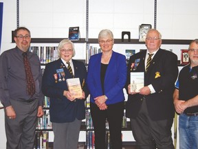 The Nanton Legion presented two history books to J.T. Foster recently. In this photo, from left, are J.T. Foster social studies teacher Roger Doucett, Nanton Legion member Marylou Slumskie, J.T. Foster learning commons facilitator Pauline Hornecker, Nanton Legion president Brian Stapley, and J.T. Foster principal Jason Porteous. Submitted photo