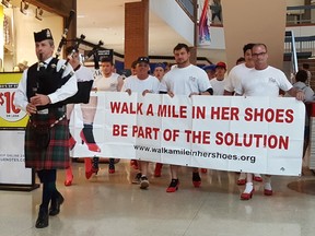 Led by a piper, participants are shown during the Men's March at the Downtown Chatham Centre on Sunday. The event supports the Chatham-Kent Women's Centre. Trevor Terfloth/Postmedia Network