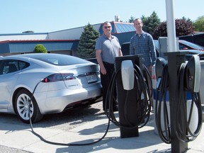 Exeter’s Syfilco recently partnered with Tesla on a pilot project that saw Tesla sponsor the installation of six electric vehicle chargers at Syfilco. In return, Syfilco employees who buy a Tesla electric vehicle will be able to charge their vehicles for free at work. Pictured above are Syfilco maintenance supervisor Richard Neevel, left, and Ryan deBoer, who works in IT and software development at the plant. Also shown is Syfilco co-owner Andy deBoer’s 2017 Tesla Model S. (Scott Nixon/Exeter Lakeshore Times-Advance)