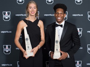 Montreal Carabins volleyball player Marie-Alex Belanger, left, of Joliette, Que., and Laurentian Voyageurs basketball player Kadre Gray, of Toronto, pose for a photograph with their trophies after being named female and male U Sports Athletes of the Year for the 2017-18 season, in Vancouver, on Monday June 4, 2018. THE CANADIAN PRESS/Darryl Dyck