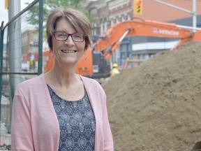 Beth Burns stands at the corner of Elgin Street and Talbot Street, near this Saturday's Downtown Dust Up. The rain-or-shine event will take place in a safe part of the construction zone where kids are encouraged to dig through a giant pile of dirt while parents check out local businesses.(Louis Pin/Times-Journal)