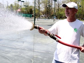 Stratford Tennis Club manager Bill White waters the four clay courts. White has worked at the club for 35 years. Cory Smith/The Beacon Herald
