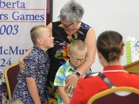 Joan Furber hugs two of her grandchildren as they congratulate her on being named the 2018 Female Senior of the Year. Laura Beamish/Fort McMurray Today/Postmedia Network