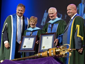 Nipissing University president Mike DeGagne (left) and chancellor Paul Cook (right) confer honorary degrees to Sharon Johnston and her husband, David Johnston, Canada's former governor general, during a convocation ceremony on Tuesday at the Sanderson Centre n Brantford. (Brian Thompson/The Expositor)