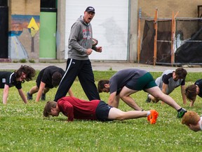 Coach Scott Chisholm leads the St. John's College senior boys rugby players through a practice on Tuesday ahead of this week's OFSAA championship in London. (Alex Vialette/The Expositor)