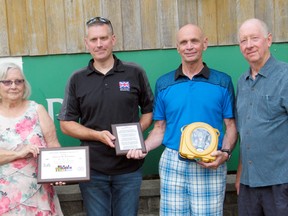 The Dave Mounsey Memorial Fund donated a defibrillator to Pinery Provincial Park on May 29 to be installed in the Visitor’s Centre. As with previous Mounsey donations, it was made in honour of a fallen law enforcement, fire, EMS or military member. The Pinery donation was made in honour of the late Pte. Patrick O’Connor, who was killed May 30, 1951 in the Korean War. Pictured from left are O’Connor’s daughter Terri of Richmond Hill, Mounsey Fund founder and executive director Patrick Armstrong, Frank Backx of Forest (the first person saved by a Mounsey-donated defibrillator) and Paul Petersen, vice-president of Friends of Pinery Park. (Scott Nixon/Exeter Lakeshore Times-Advance)