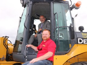 BRUCE BELL/THE INTELLIGENCER
Belleville Mayor Taso Christopher (in cab) and Joe Reid, the city’s general manager of transportation and operations, are pictured trying out a John Deere loader during the Association of Ontario Road Supervisors trade show. The two-day event is being held at the Quinte Sports and Wellness Centre on Wednesday and Thursday.